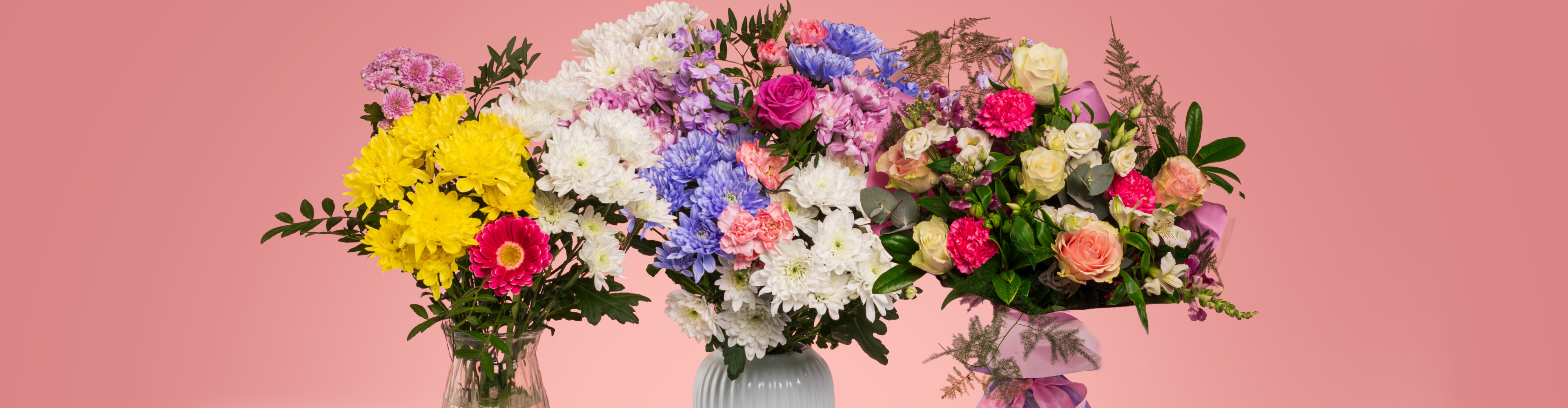 Three vibrant bouquets featuring yellow, white, pink, and blue flowers on a pink background.